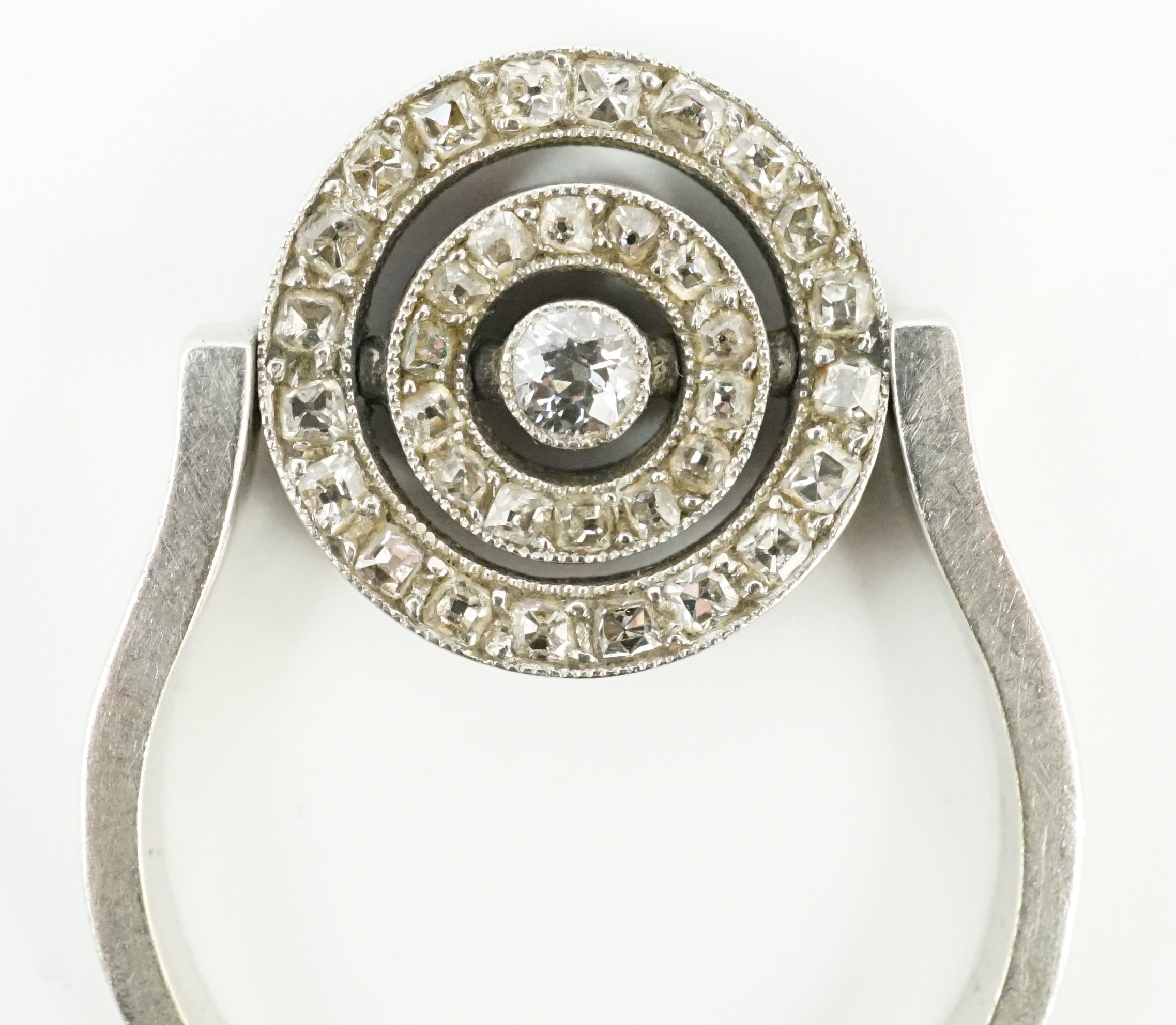 A platinum?, ruby and diamond cluster set swivelling target ring